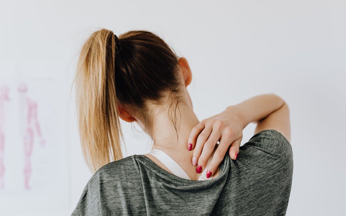 Person holding neck showing neck and upper-trap pain
